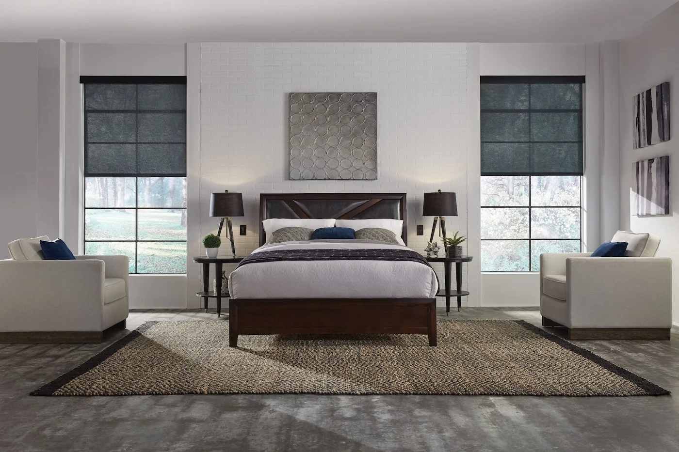 Serene primary bedroom with motorized roller shades lowered on two large windows, creating a calm, private retreat